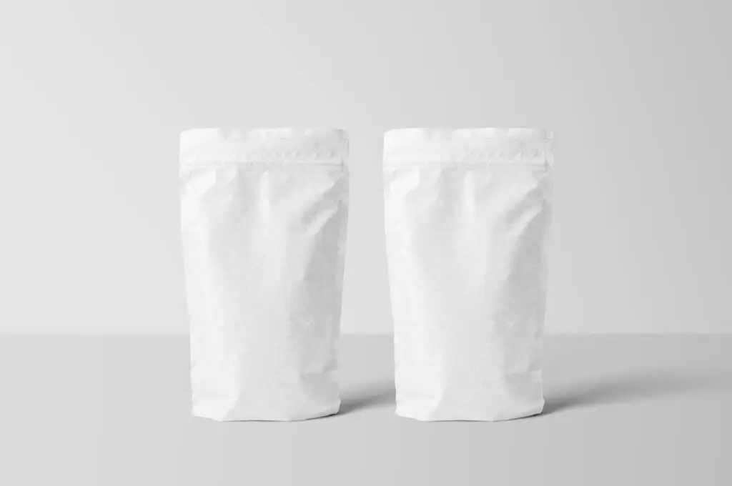 pexels-photo-12024976-12024976 Two white paper stand-up pouches for packaging mockup on a clean surface.